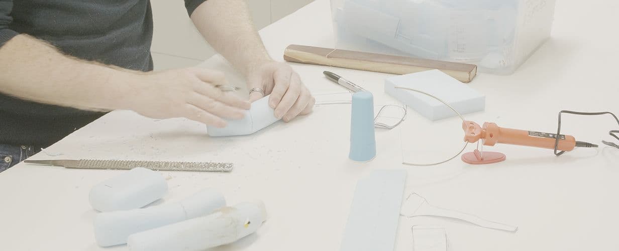 A designer working with cardboard and soft form, to develop a prototype
