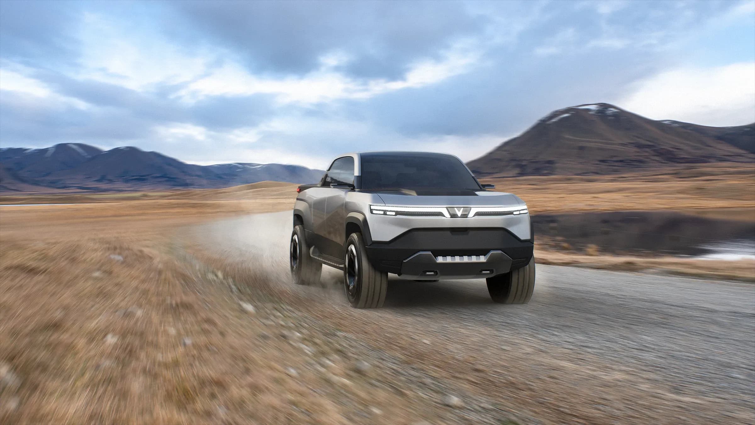 Vinfast promotional graphic, driving on a rocky road in tundra