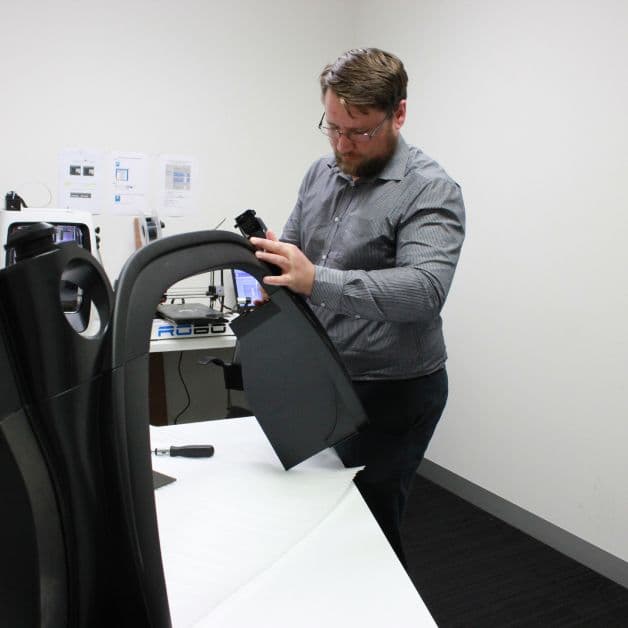 A technician assembles parts during testing