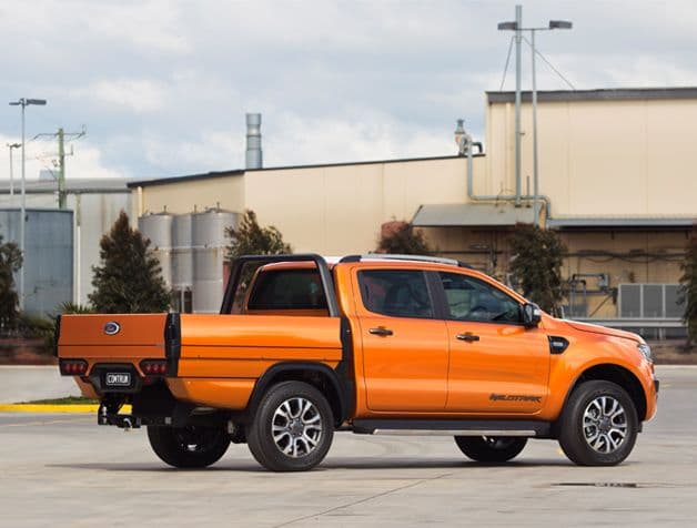 Actual implementation of the tray, on a work vehicle in quality orange, showing back
