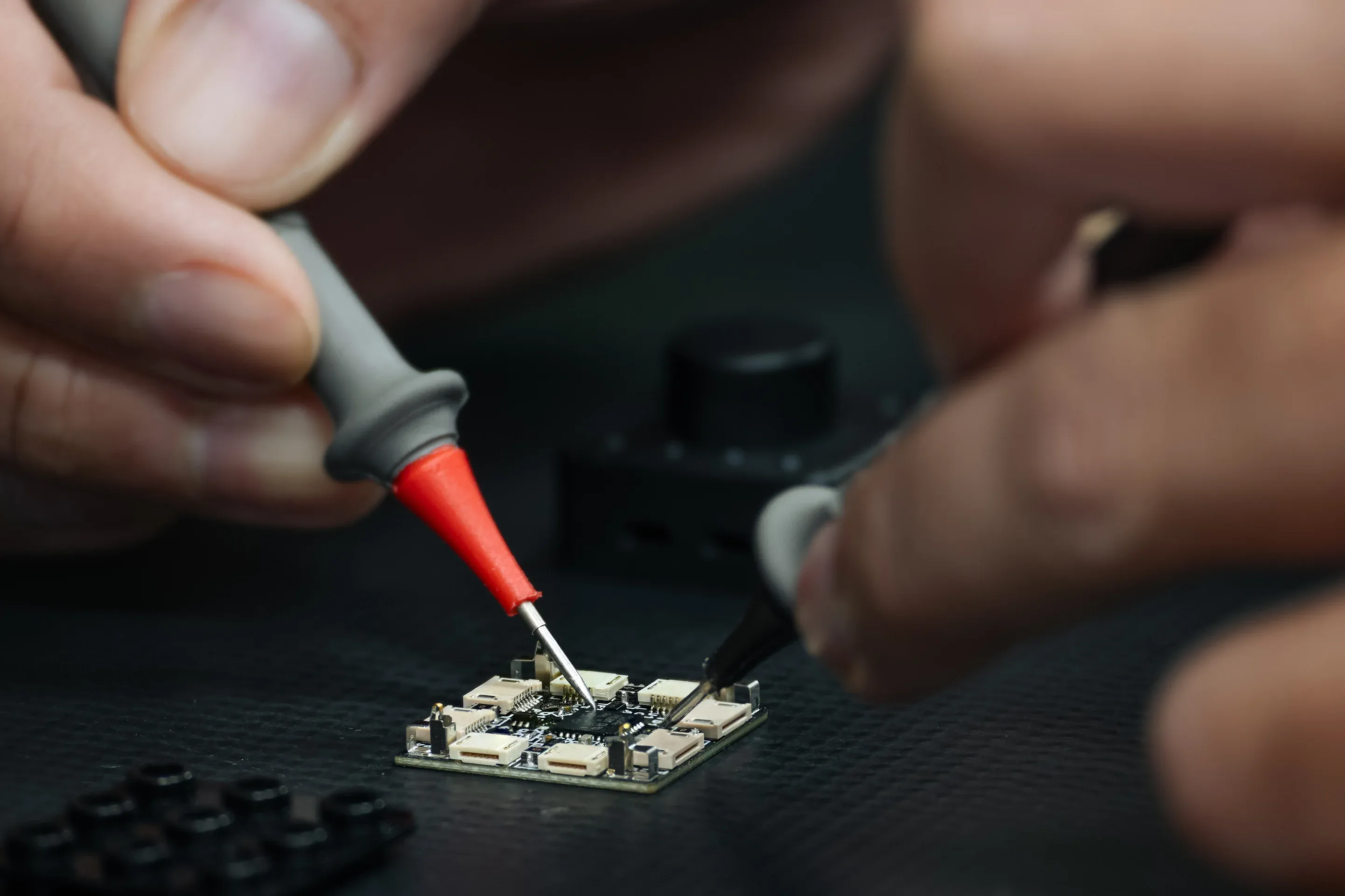 Engineer soldering the PDB board of the controller