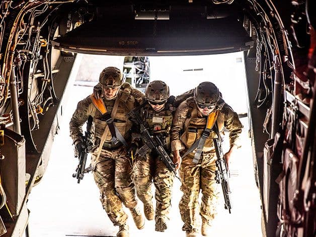 Fleetseat in use, helping carry a wounded soldier into a plane