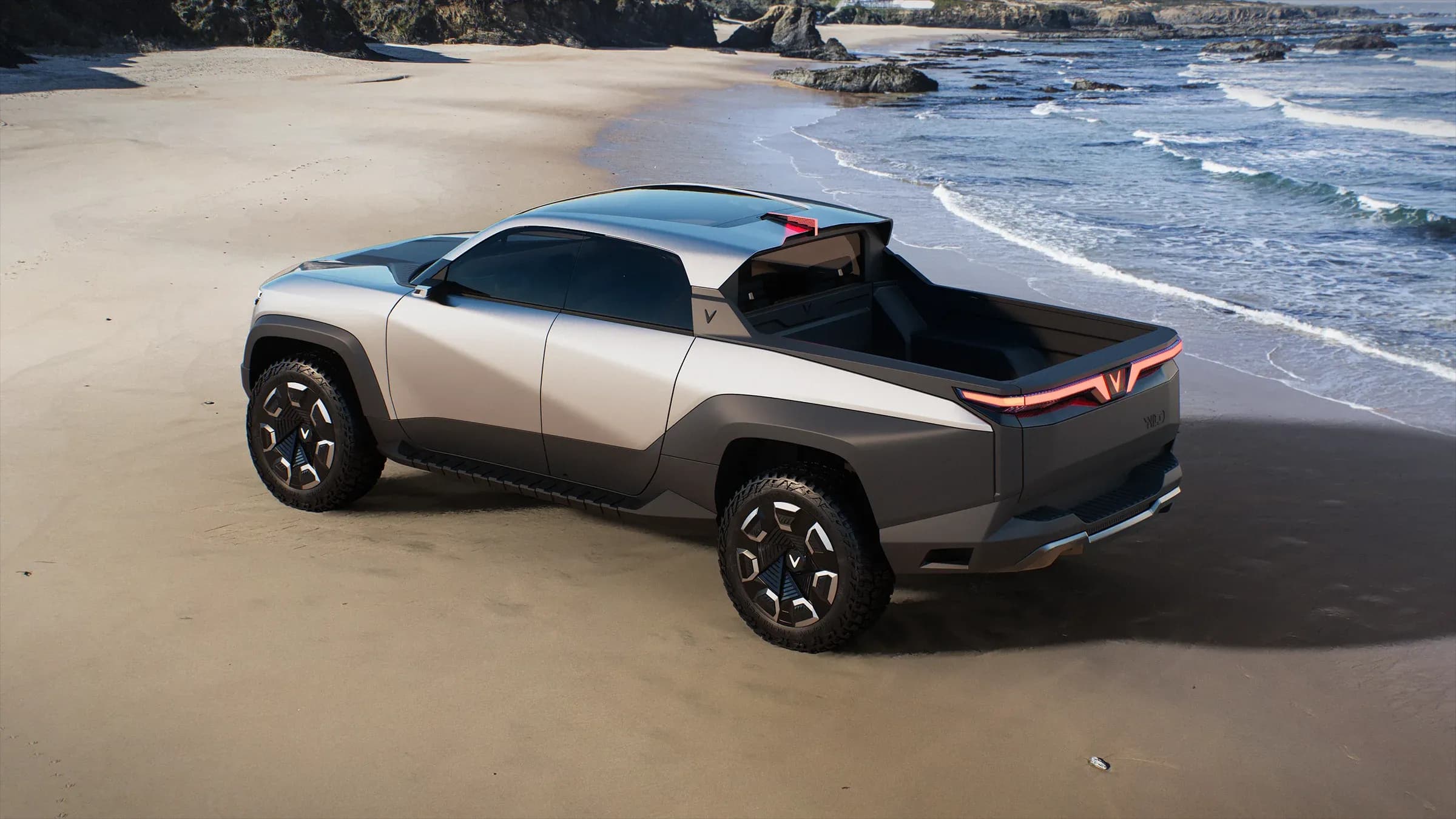 Slightly eleveated promotional photo of the vinfast at a beach, showing the designed lines of the vehicle