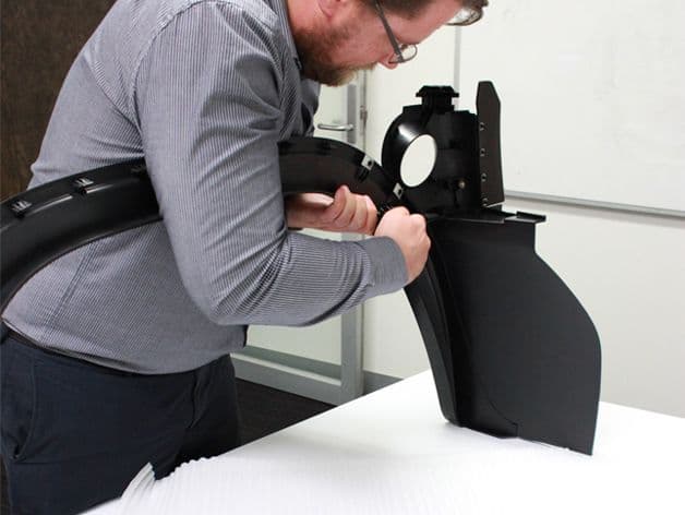A technician assembles parts during testing