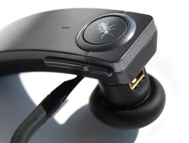 Close up view of the bud, charging port, and buttons